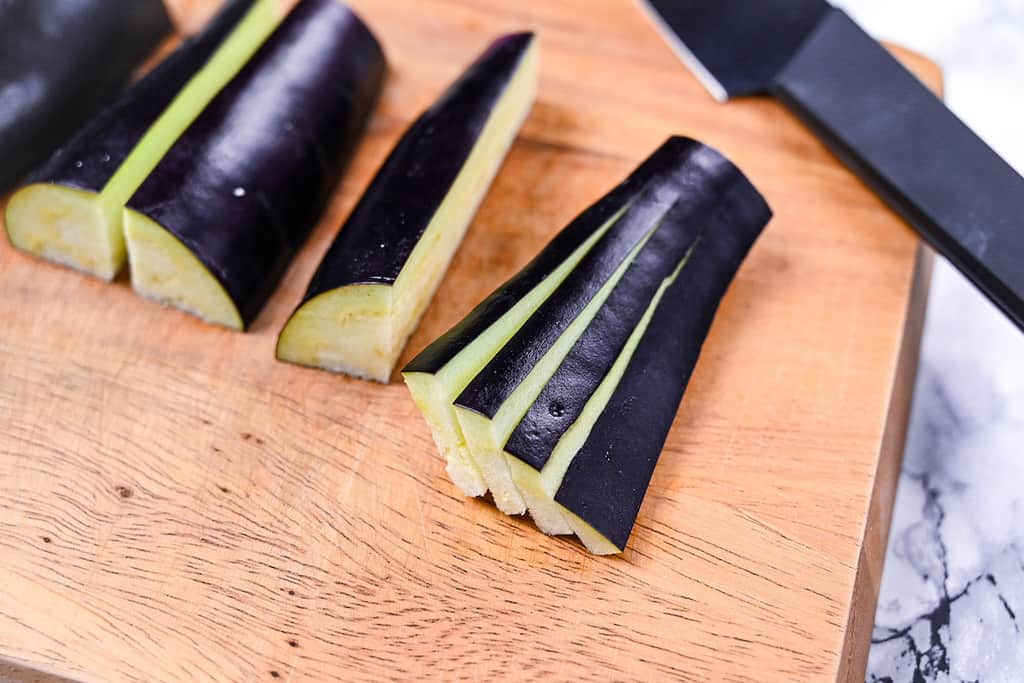 Cut eggplant slices and spread to make a fan shape