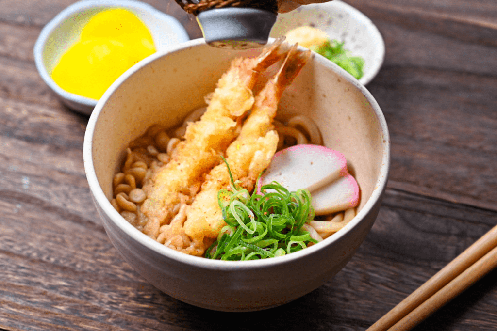 Sprinkling shrimp tempura udon with shichimi togarashi