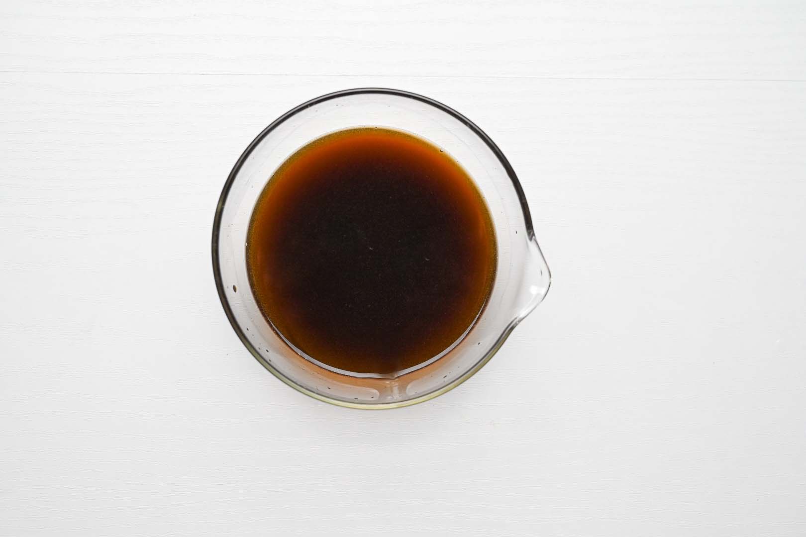 mixing teriyaki style sauce in a small glass bowl