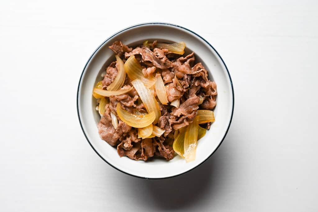 Rice topped with beef and onions