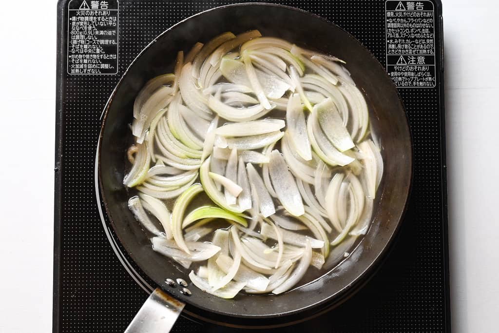 Simmering onions in broth for oyakodon