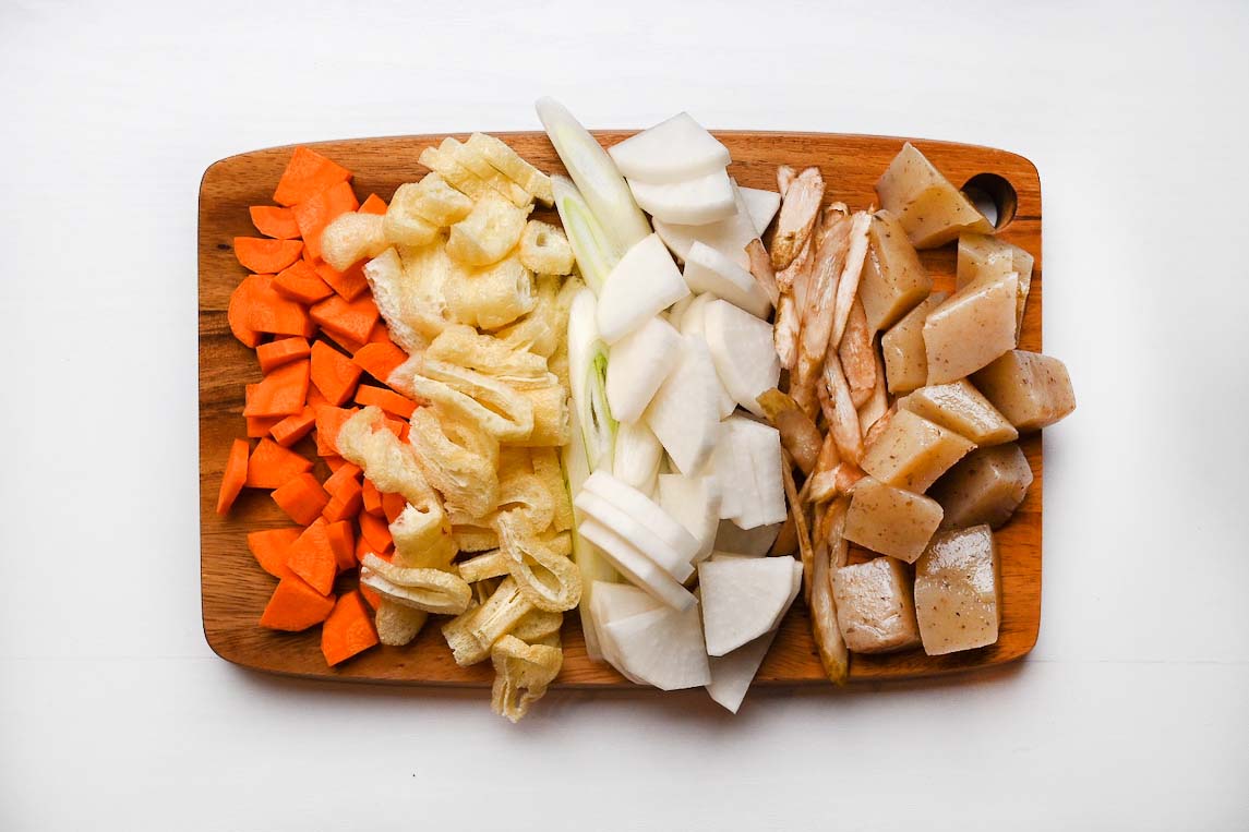 Cut vegetables on a wooden chopping board for kenchin jiru