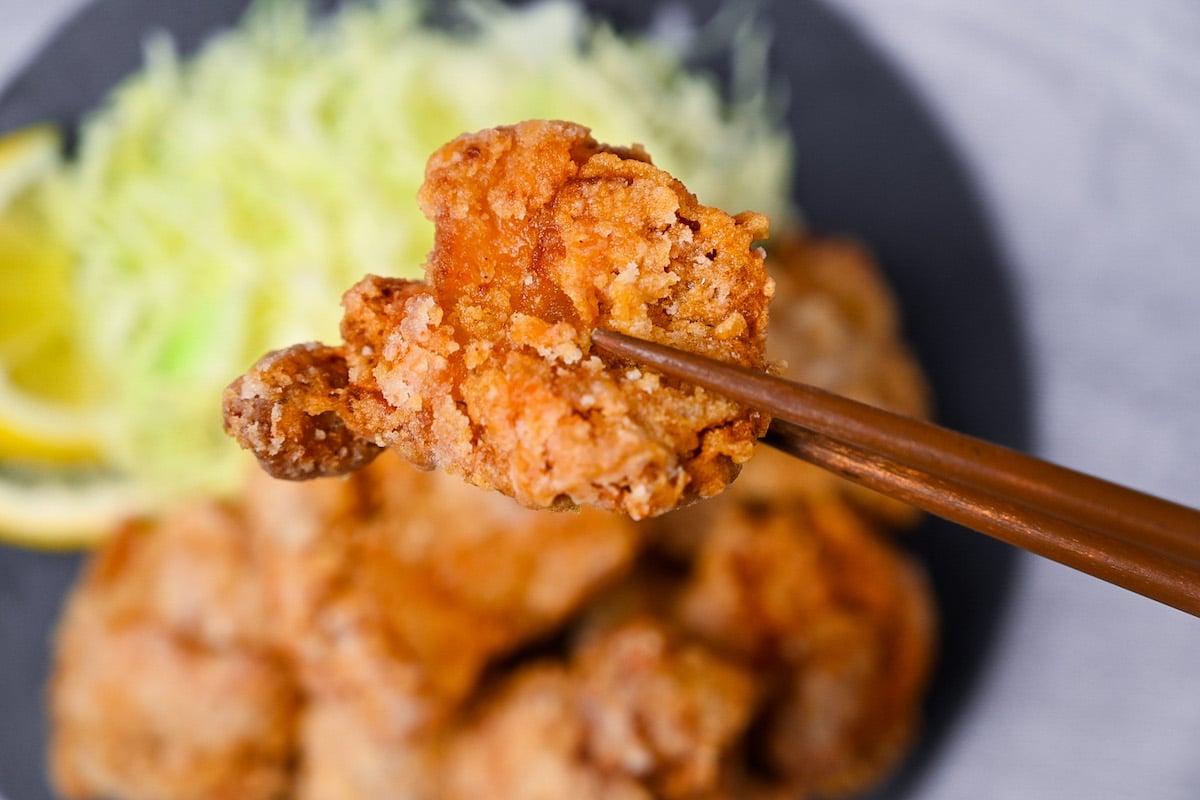 Japanese chicken tatsuta age served on a slate slate with cabbage and lemon