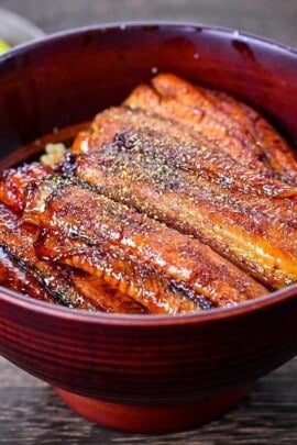 Unagi don (Japanese Grilled Eel Rice Bowl) sprinkled with sansho Japanese pepper featured