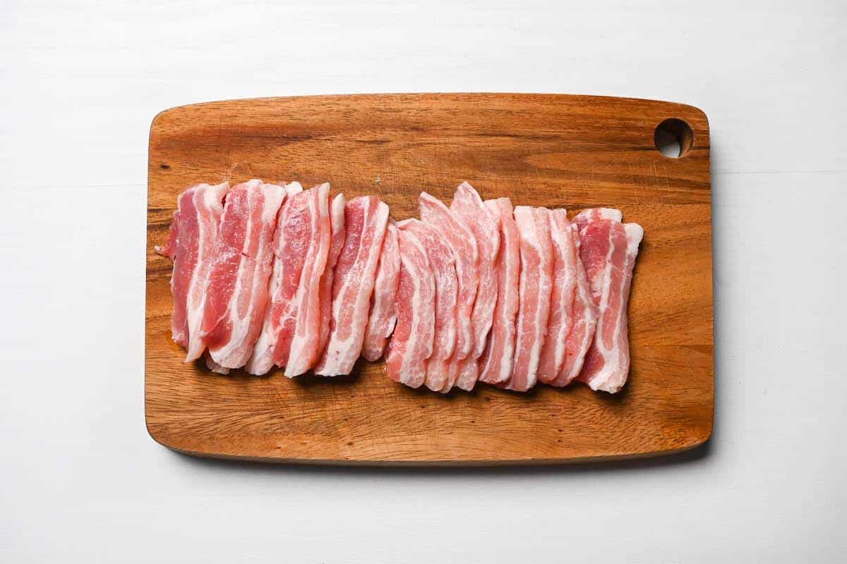 cut pork belly on wooden chopping board