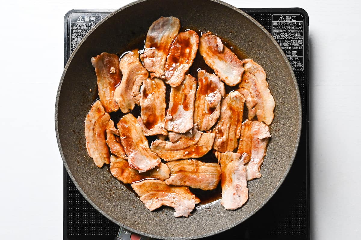 Cooked pork belly in frying pan with caramel soy sauce