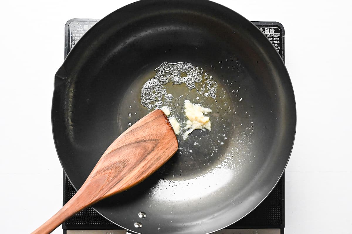 Frying garlic paste in a wok