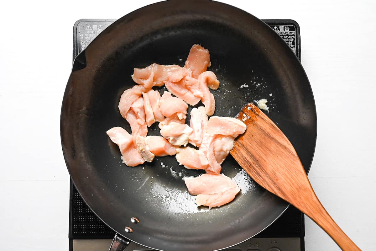 Frying chicken breast in a wok