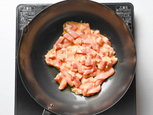 frying pork for chinjao rosu in a wok
