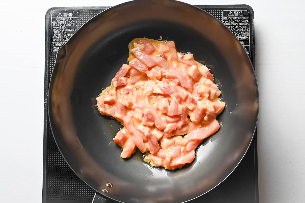 frying pork for chinjao rosu in a wok