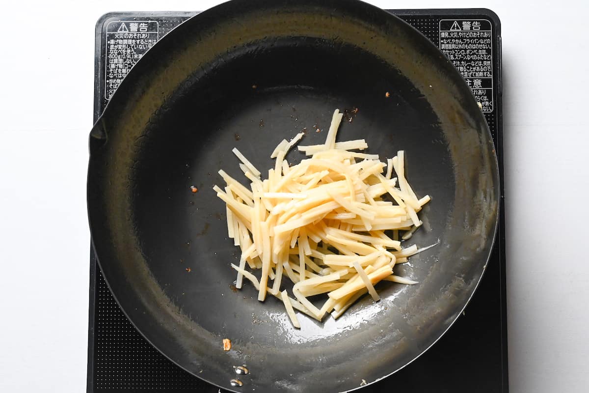 frying bamboo shoots in wok for chinjao rosu