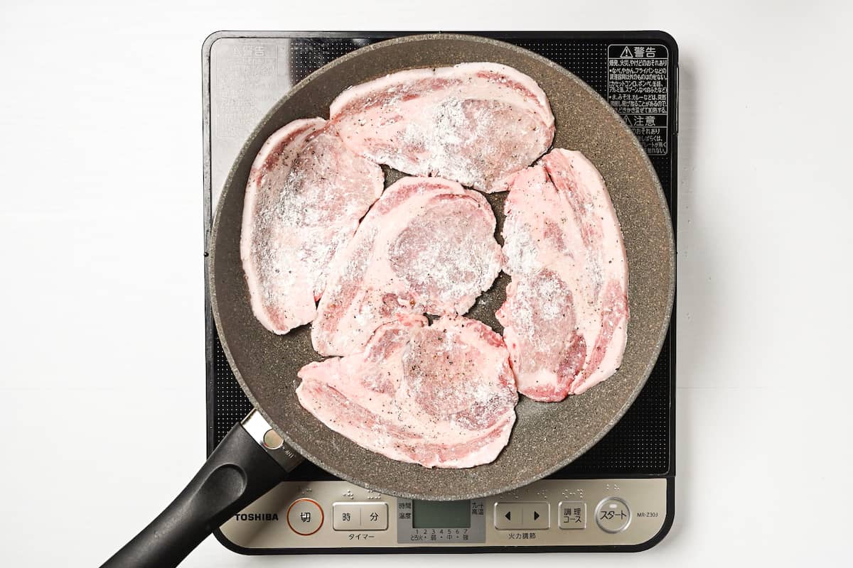 placing pork in pan for shogayaki