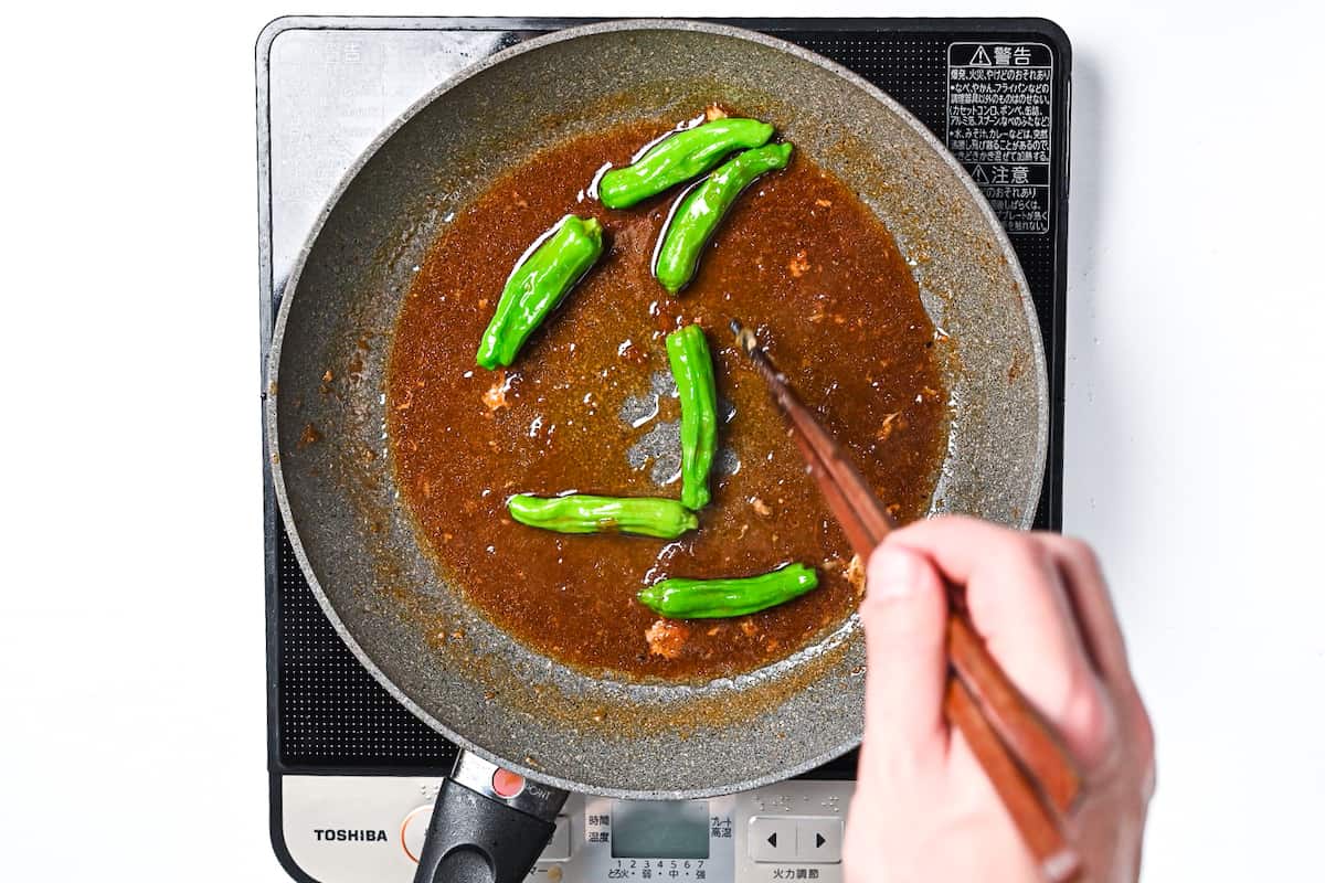 frying shishito peppers in leftover shogayaki sauce