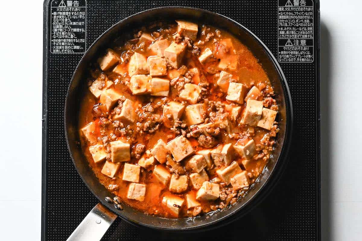 Turn off heat and drizzle mapo tofu with chili oil