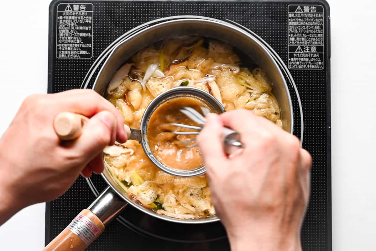 whisking miso paste into broth