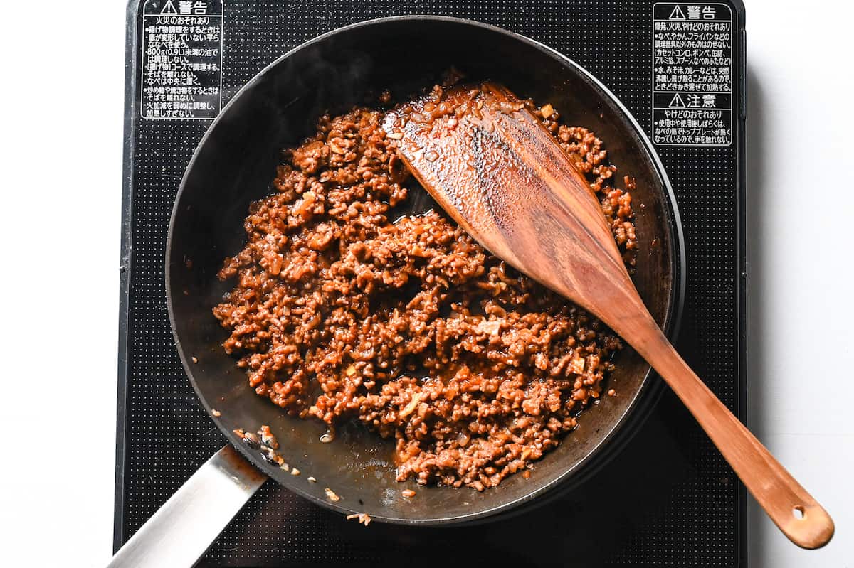 cooking ground beef with Japanese condiments to make taco rice