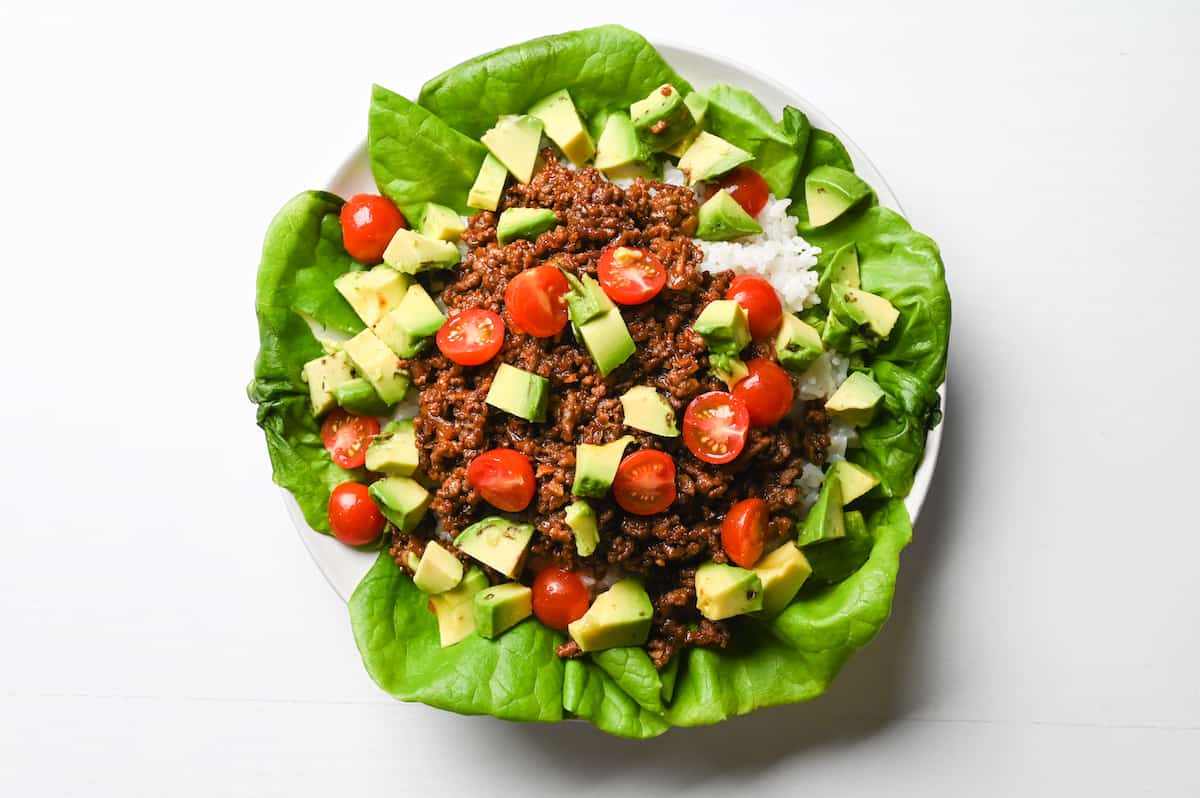 Taco rice sprinkled with tomatoes and avocado