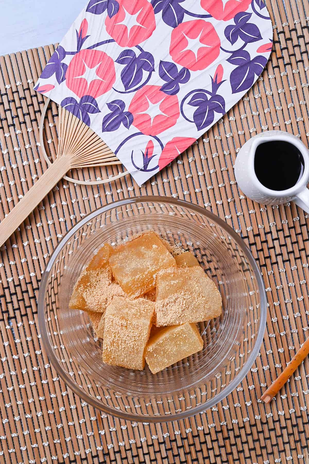 Homemade warabi mochi in a glass bowl coated with kinako roasted soy bean powder