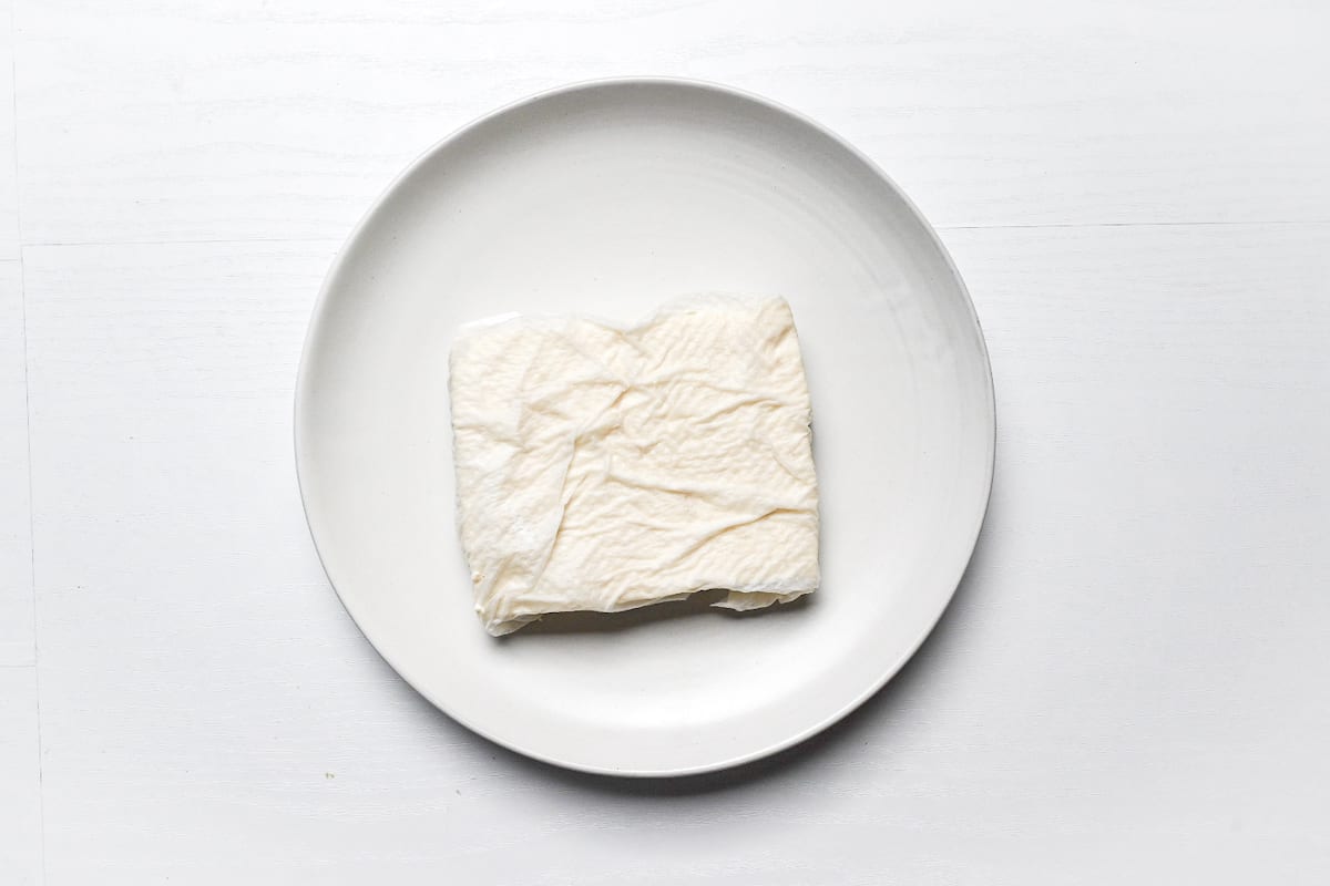 Firm tofu wrapped in kitchen paper