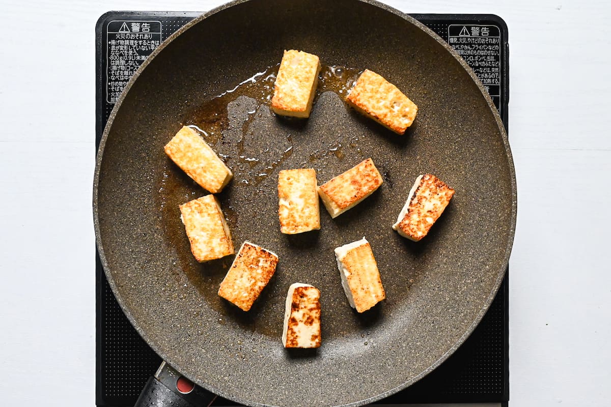 Browned firm tofu in a frying pan