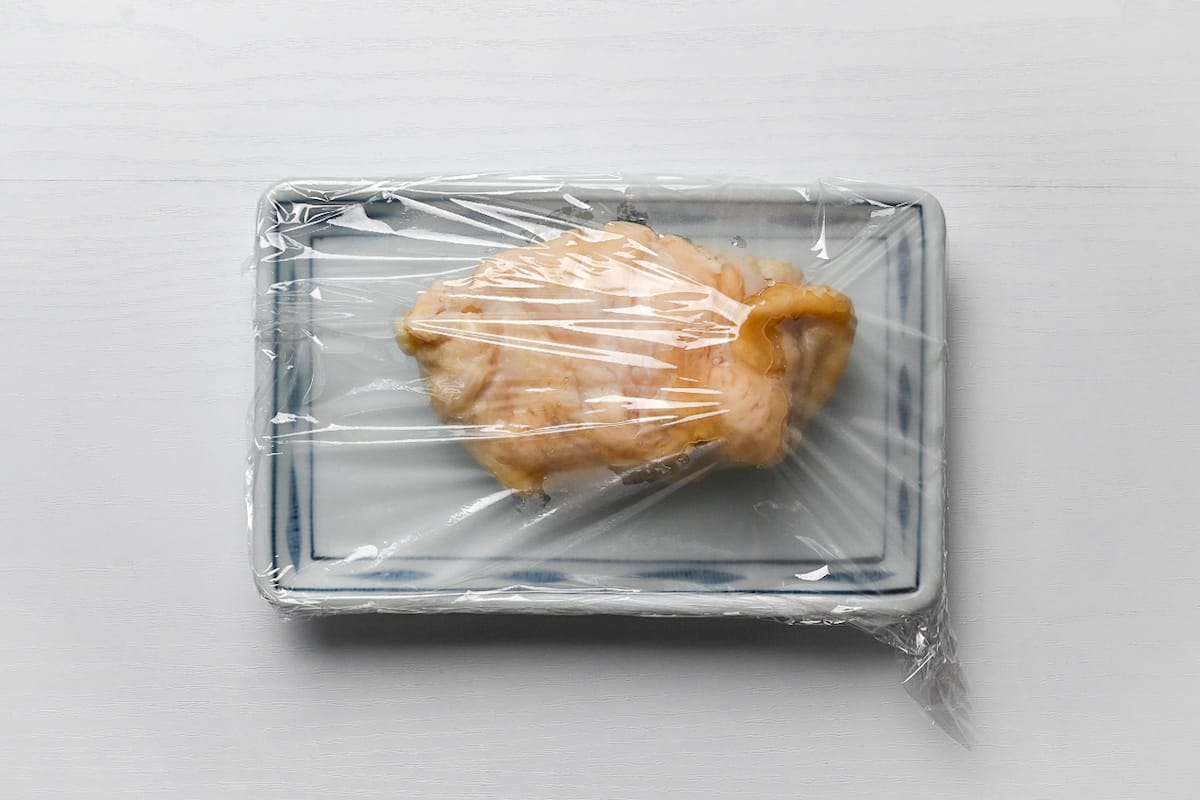 resting chicken breast on a rectangular plate