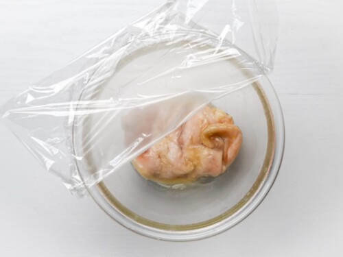 chicken breast microwaved in a glass bowl
