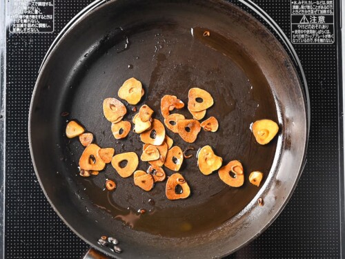crispy garlic chips fried in a frying pan