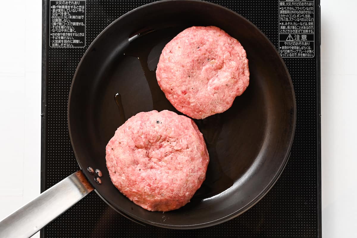 frying hamburg steak in a frying pan