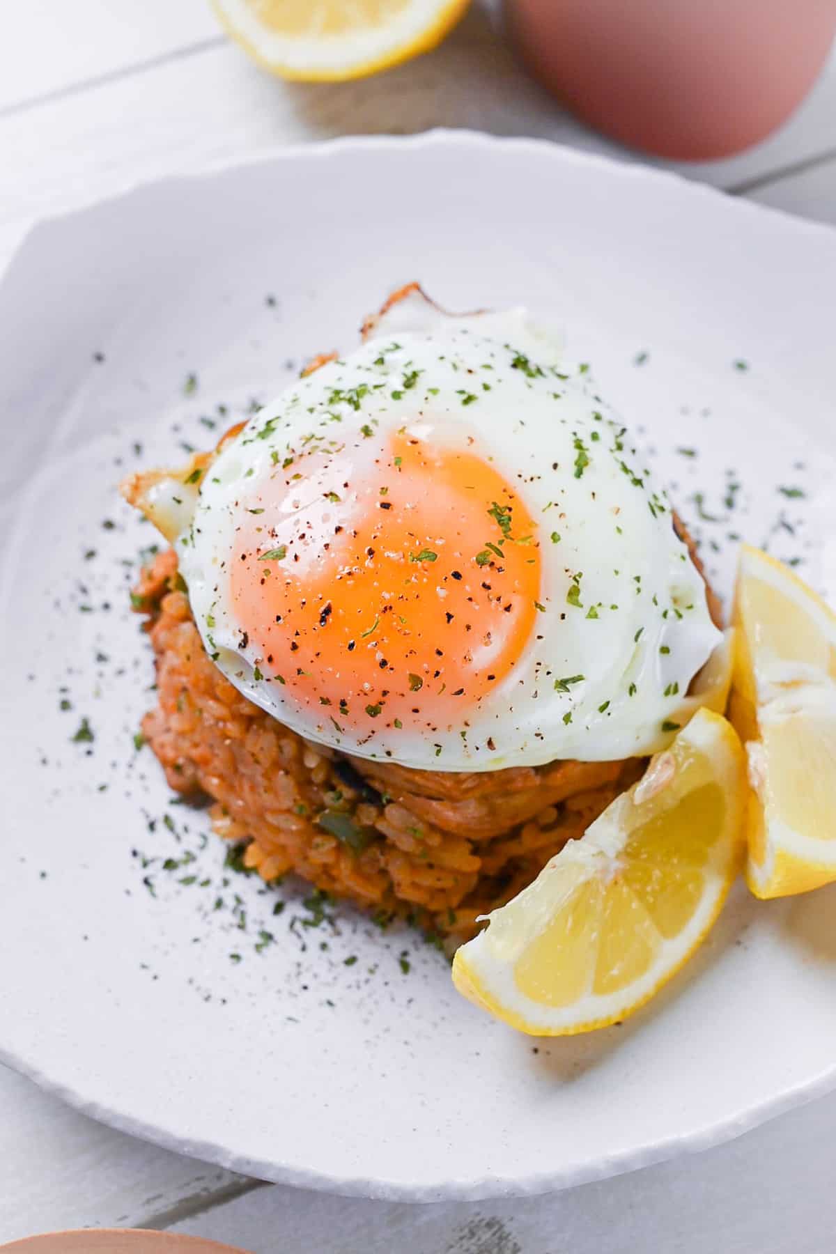 Japanese ketchup rice (chicken rice) topped with egg and served with lemon wedges