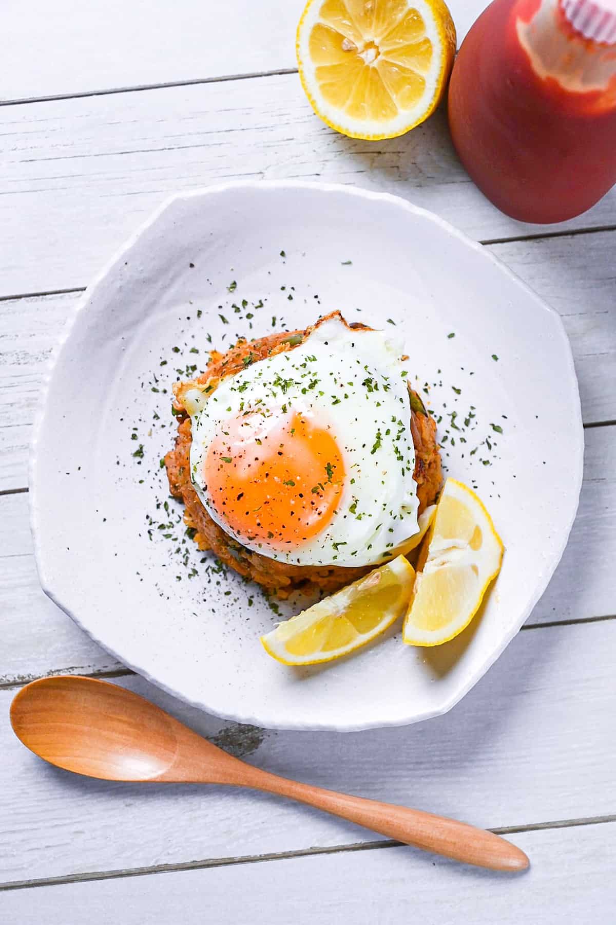 Japanese ketchup rice (chicken rice) topped with egg and served with lemon wedges