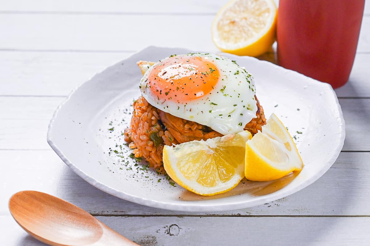 Japanese ketchup rice (chicken rice) topped with egg and served with lemon wedges