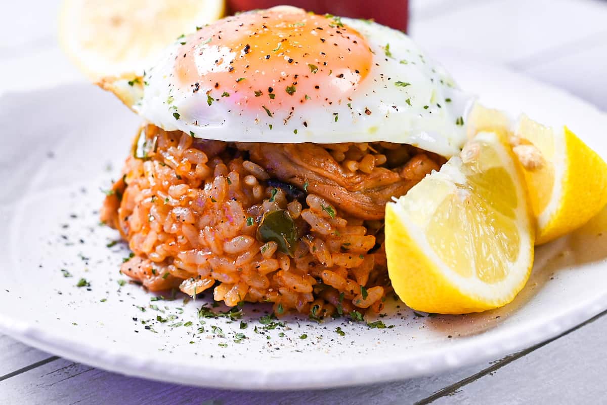 Japanese ketchup rice (chicken rice) topped with egg and served with lemon wedges