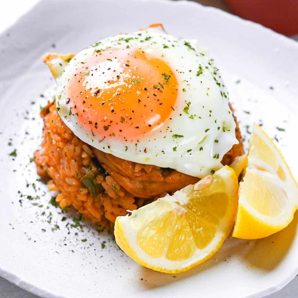 Japanese ketchup rice (chicken rice) topped with egg and served with lemon wedges