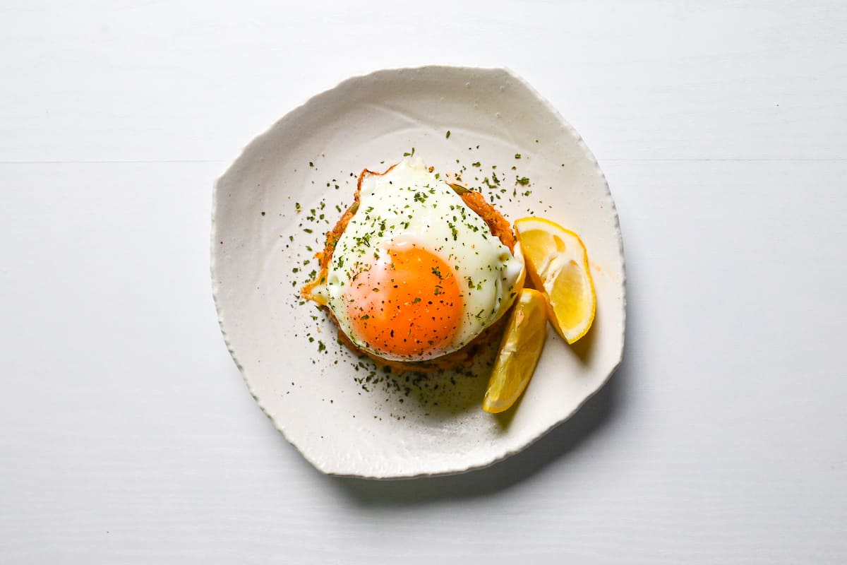 Japanese ketchup fired rice topped with a fried egg and served with lemon wedges