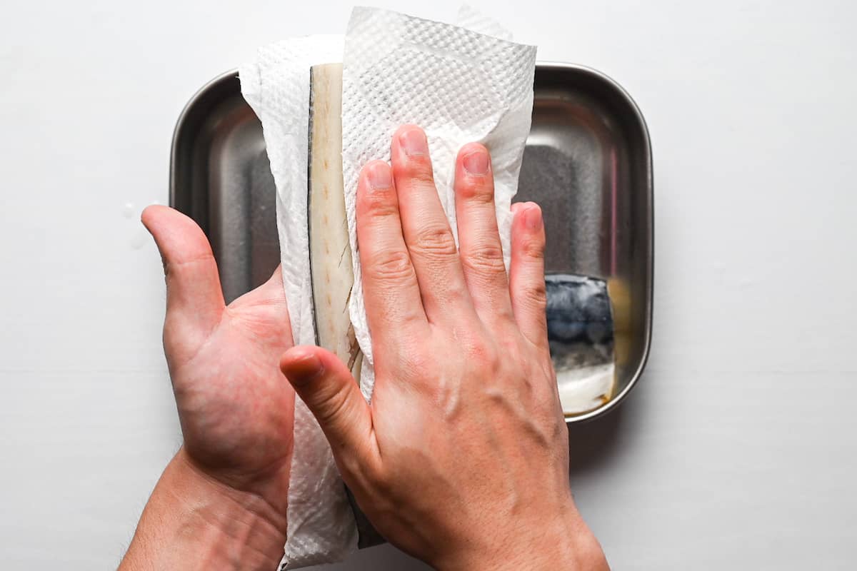 patting mackerel dry with kitchen paper