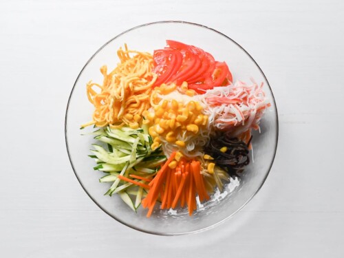 somen salad complete with julienned vegetables, shredded imitation crab and thinly sliced egg crepe (kinshi tamago)