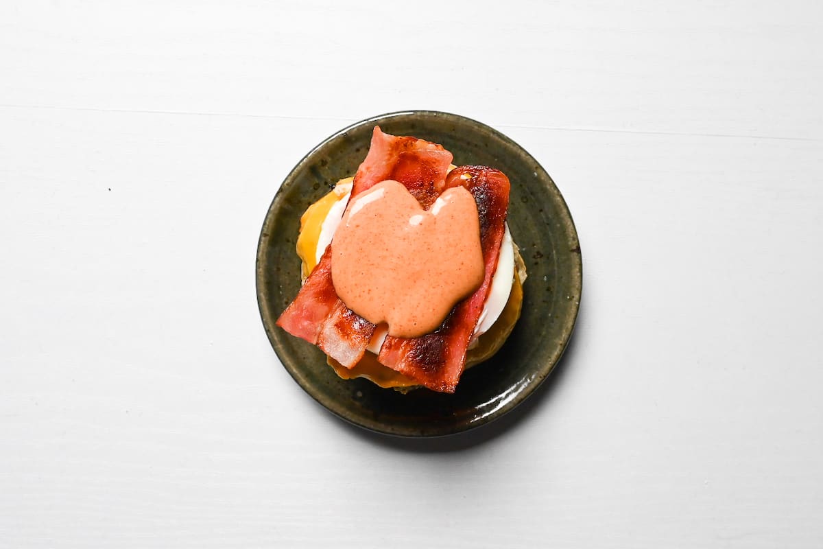tsukimi burger sauce on top of bacon rashers
