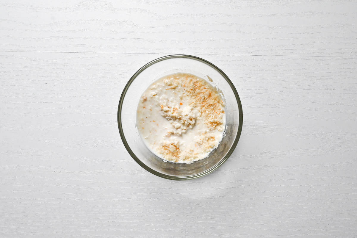 milk and panko breadcrumbs mixed in a small glass bowl