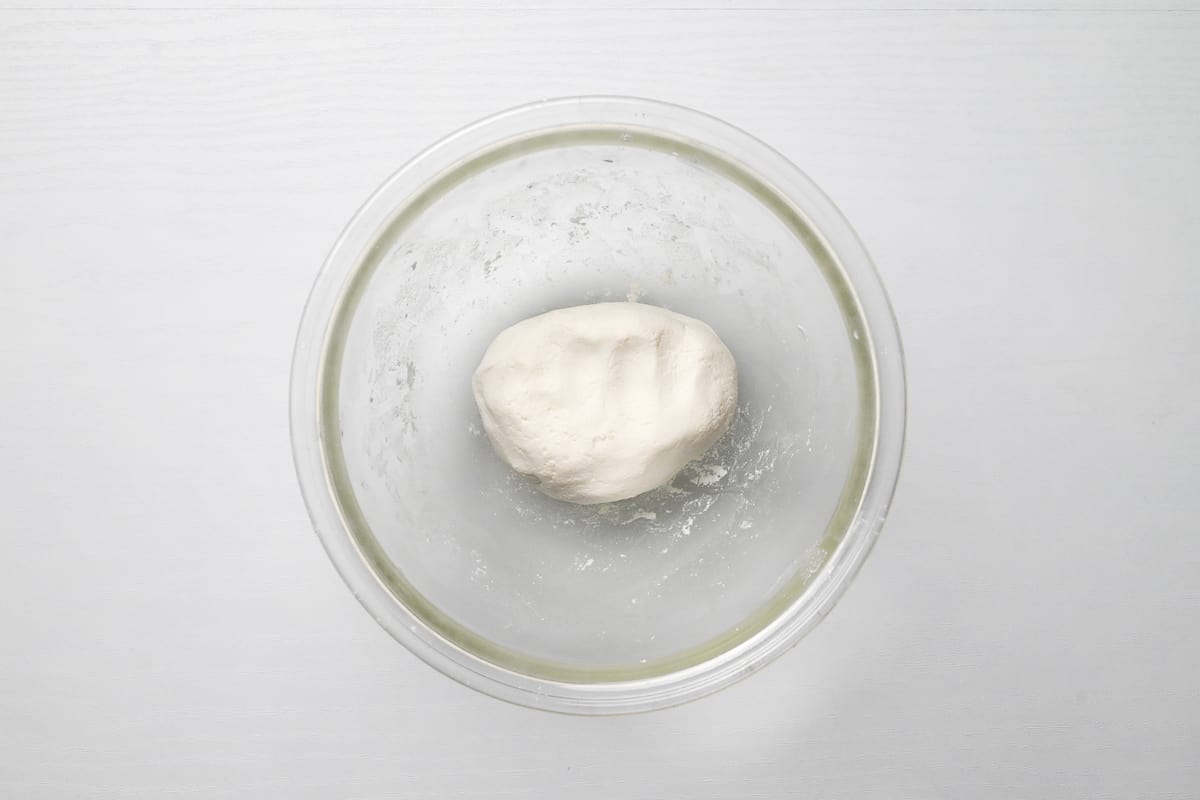 shiratamako and tofu kneaded together to form a dough in a glass bowl