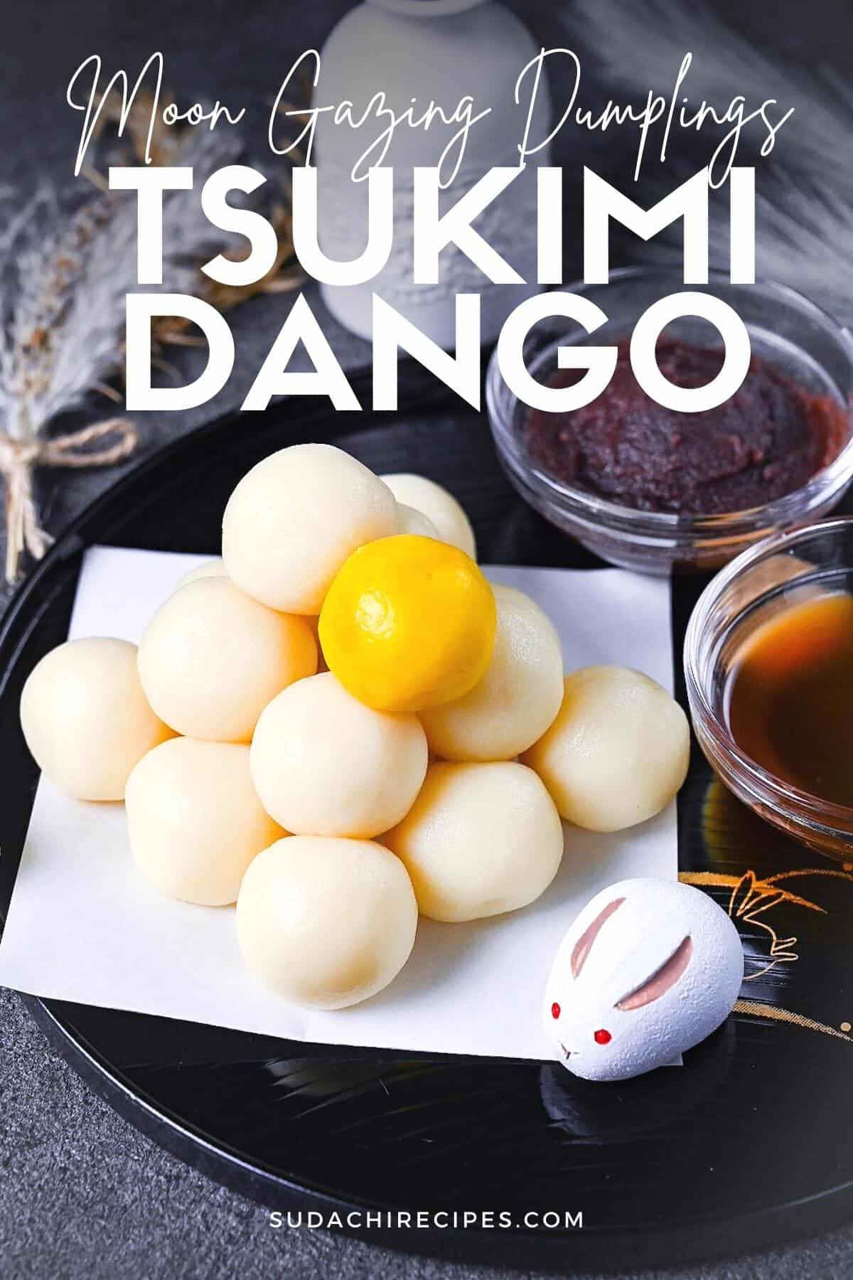 tsukimi dango moon gazing dumplings on a black tray decorated with gold rabbits