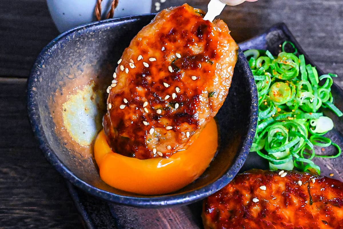 dipping chicken tsukune into raw egg yolk