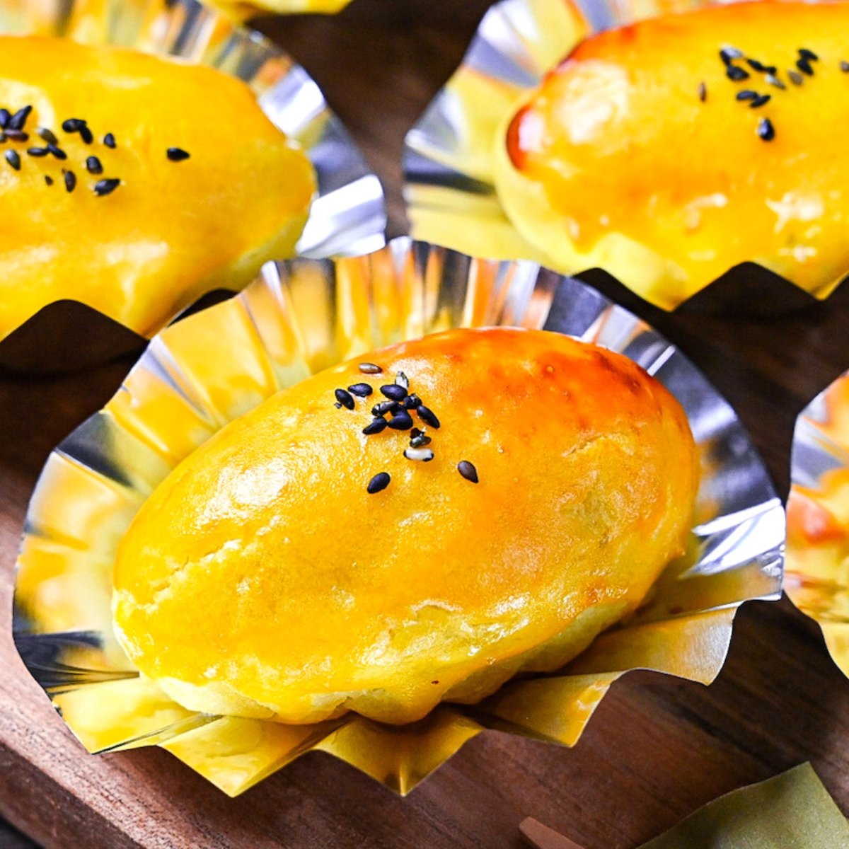 Japanese sweet potato dessert in foil cases sprinkled with black sesame seeds