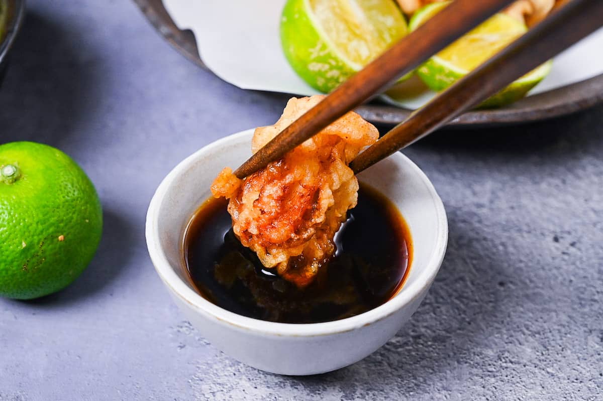 Toriten (chicken tempura) piece dipped in kabosu dipping sauce