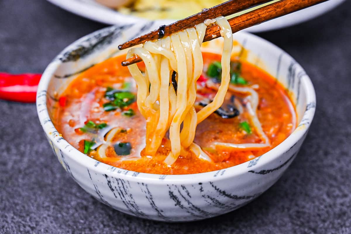 Ramen noodles dipped in a spicy tsukemen soup