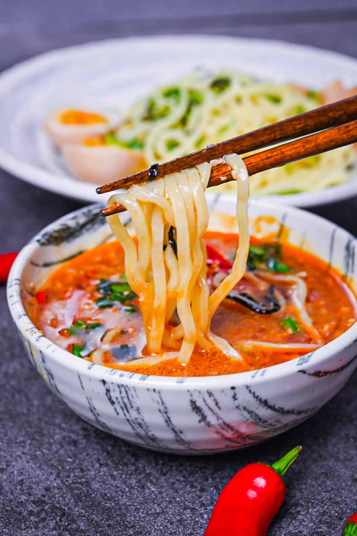 Ramen noodles dipped in a spicy tsukemen soup