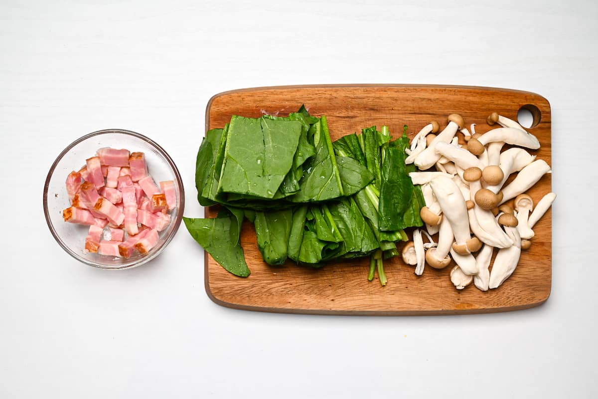 Butter shoyu pasta ingredients cut and laid out on a wooden chopping board