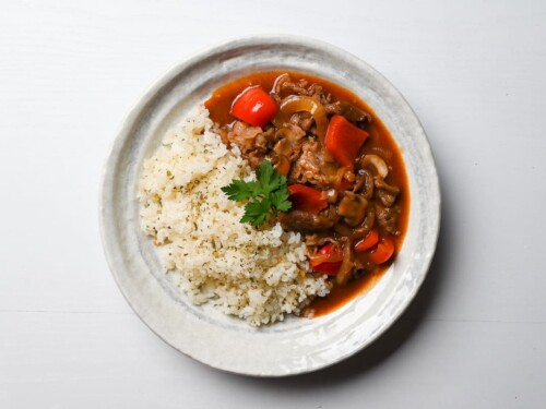Beef Hayashi Rice served on a white plate with fresh parsley