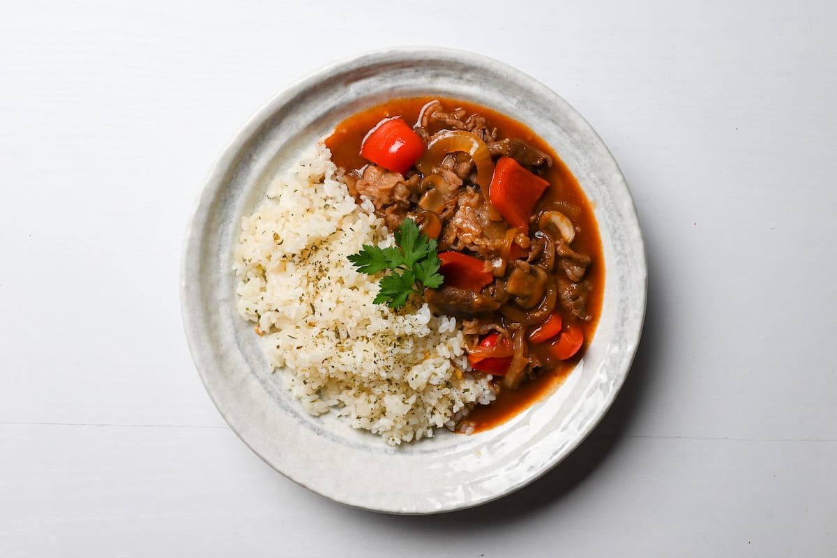 Beef Hayashi Rice served on a white plate with fresh parsley