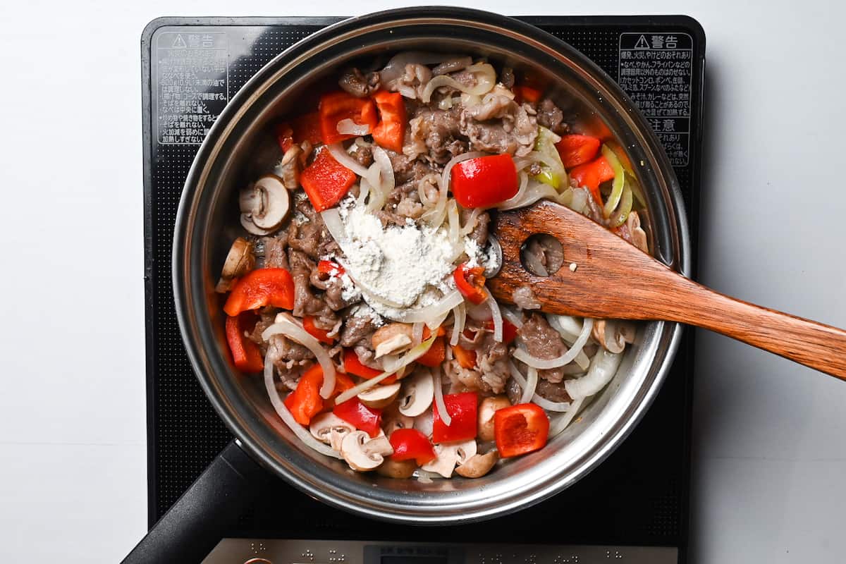 flour added to hayashi rice ingredients in a pan