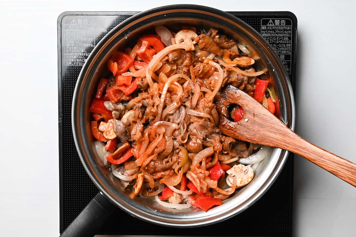 hayashi rice cooking in a pan with red wine and Worcestershire sauce added